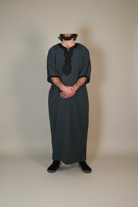 Khayr Thobes charcoal grey thobe with black embroidery on neckline and cuffs. Relaxed fit, breathable fabric.