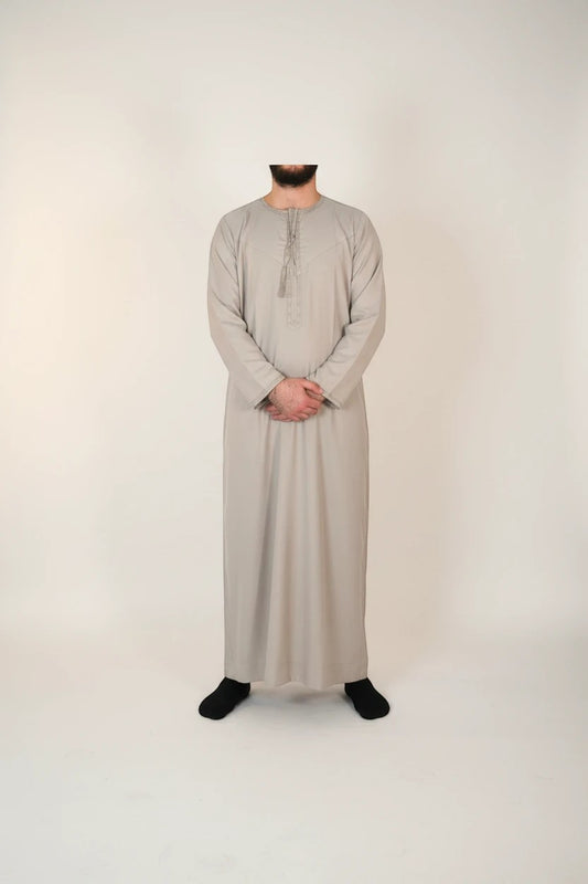 Khayr Thobes traditional Islamic thobe robe in light grey, featuring decorative tassels and a classic flowing silhouette.