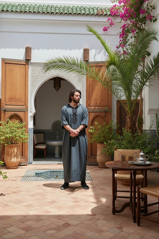 Khayr Thobes charcoal grey thobe with black embroidery on neckline and cuffs, relaxed fit, breathable fabric.