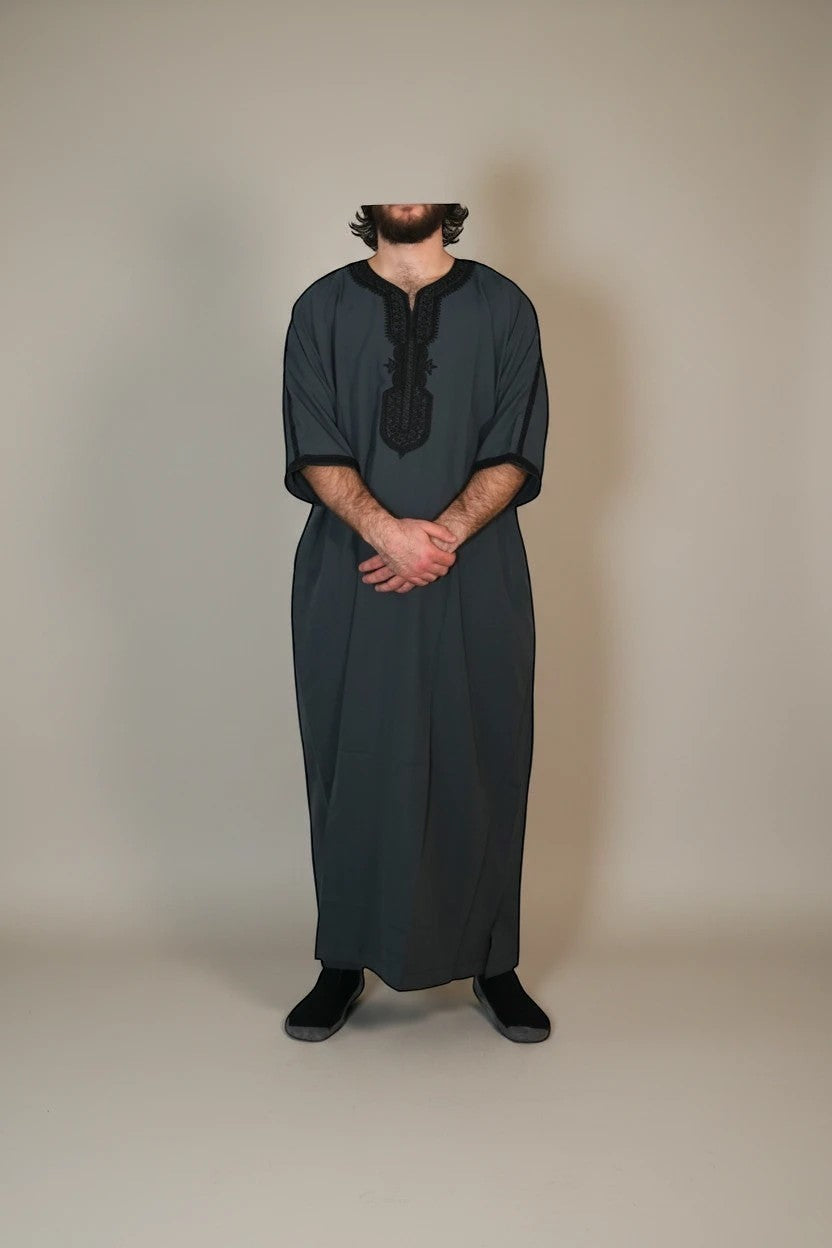 Khayr Thobes charcoal grey thobe with black embroidery on neckline and cuffs. Relaxed fit, breathable fabric.