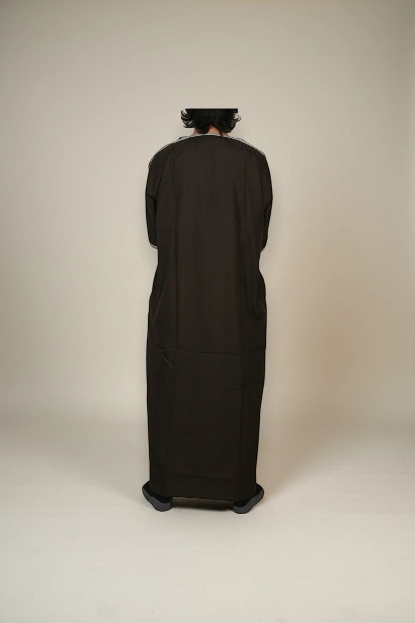 Khayr Thobes dark brown embroidered kaftan thobe with silver trim on neckline and cuffs. Relaxed fit with side pockets.