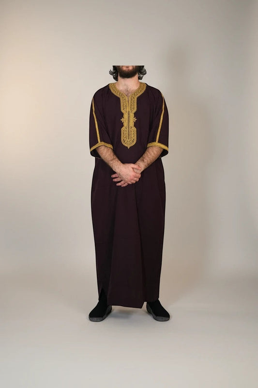Khayr Thobes deep plum embroidered kaftan thobe with gold trim on neckline and cuffs, relaxed fit, side slits.