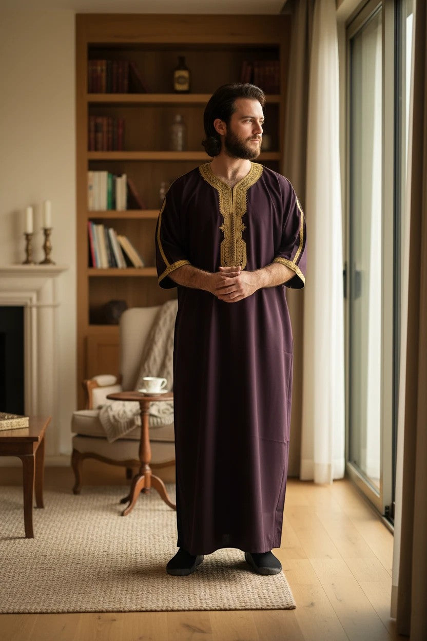 Khayr Thobes deep plum embroidered kaftan thobe with gold trim on neckline and cuffs. Relaxed fit, side slits.