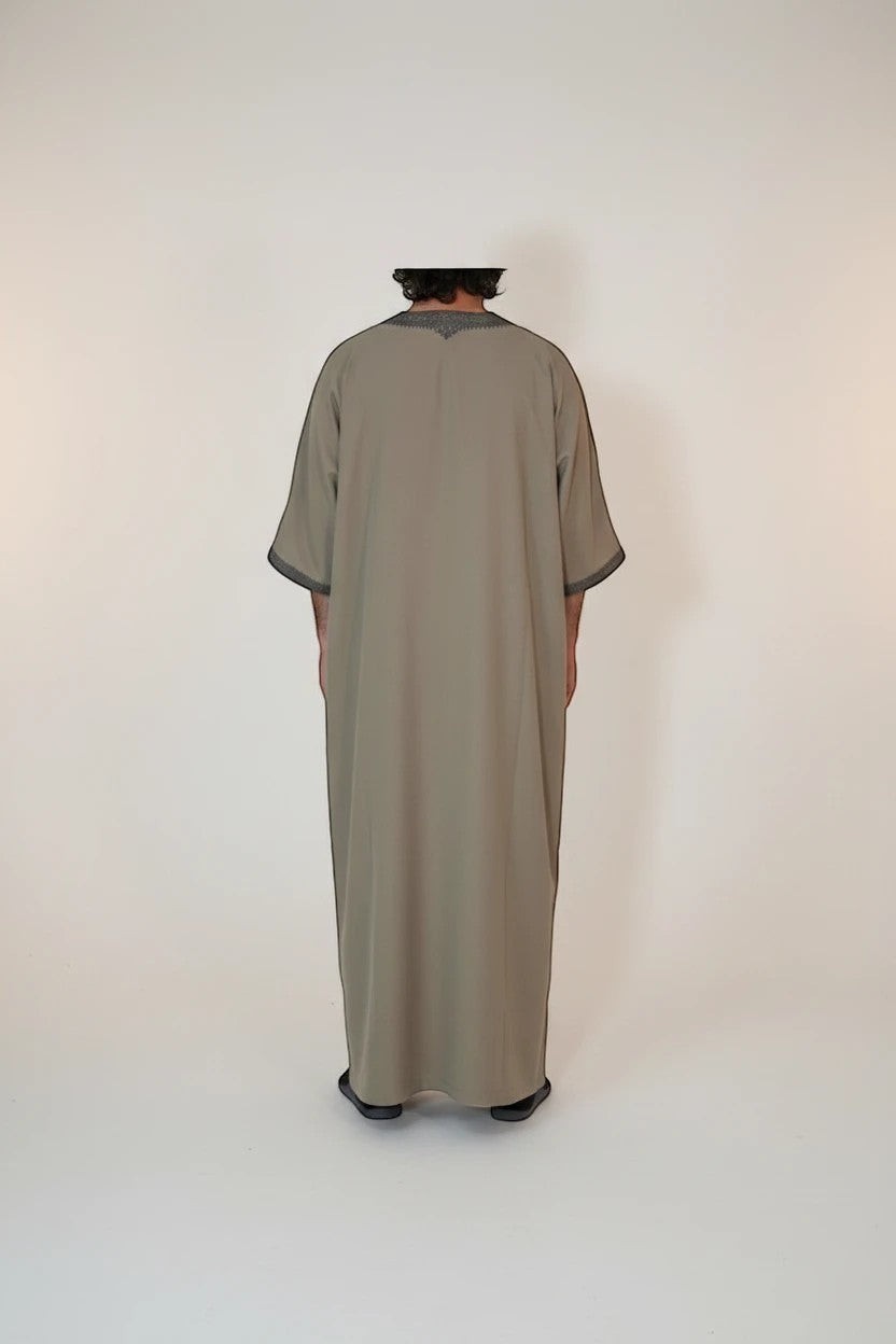 Khayr Thobes men's traditional thobe in neutral tone with embroidered neckline and cuffs. Relaxed fit, floor-length.
