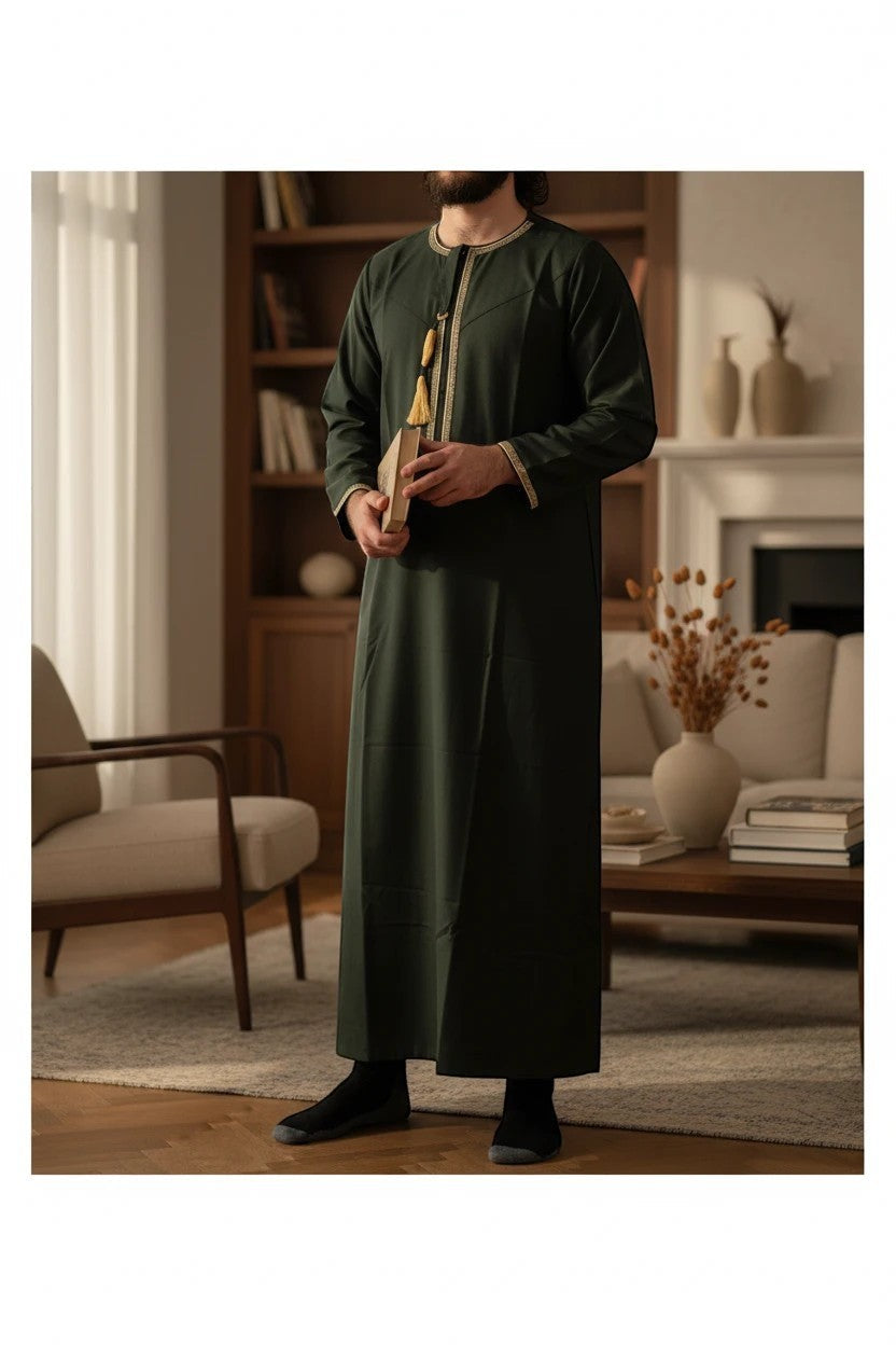 Khayr Thobes forest green men's long sleeve thobe with gold trim and tassel detail.