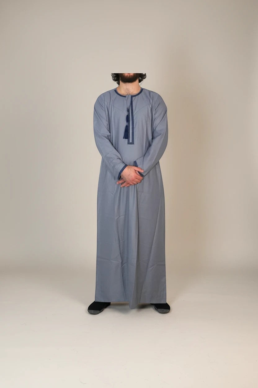 Khayr Thobes grey long sleeve thobe with navy trim and tassel detail. Men's modest wear.