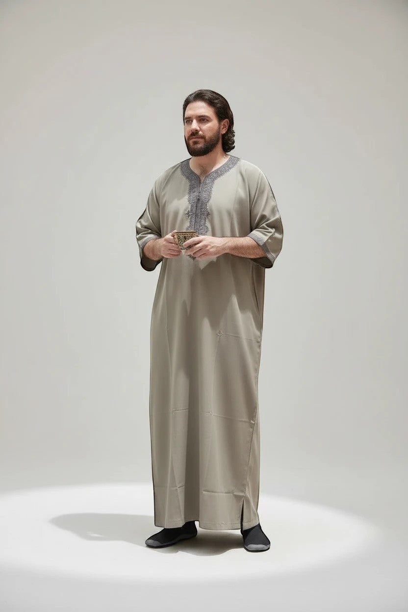 Khayr Thobes men's light grey traditional thobe with intricate grey embroidery on the neckline and cuffs.
