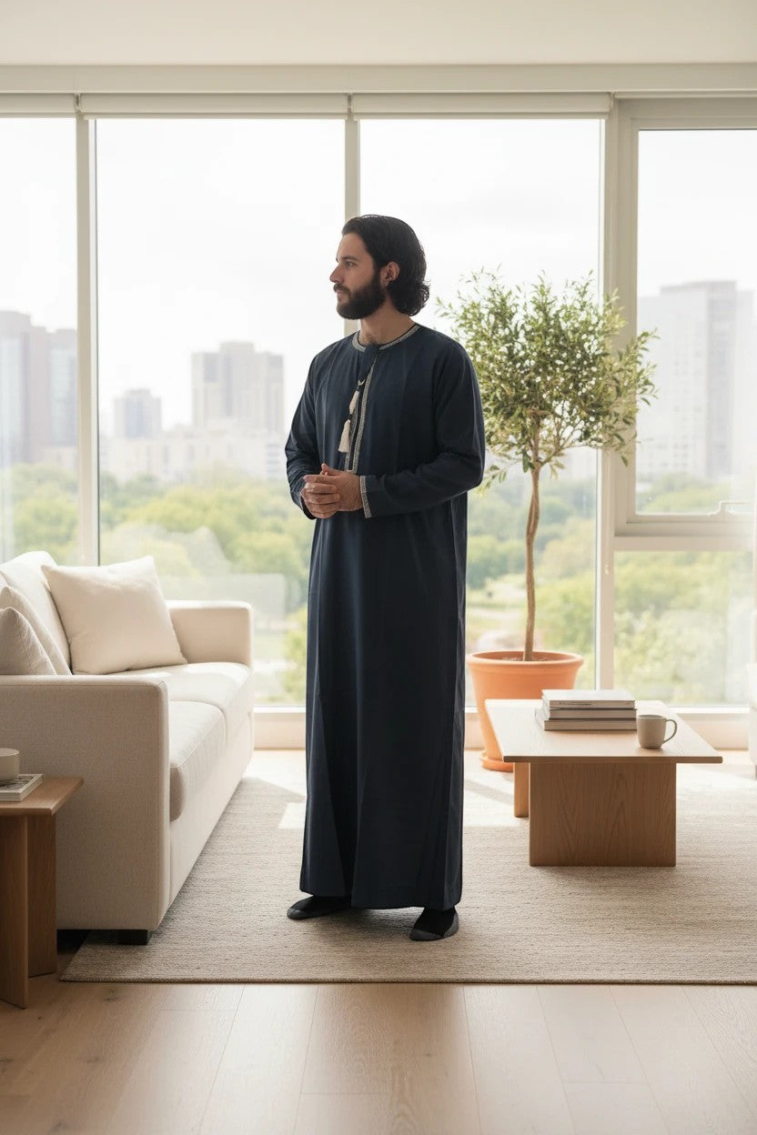 Khayr Thobes men's navy long sleeve thobe with tassel detail and refined neckline. Made from breathable fabric.