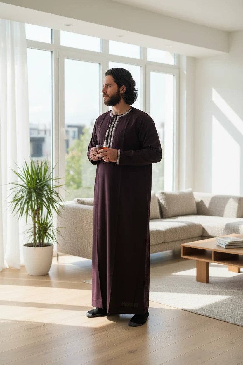 Khayr Thobes deep plum traditional thobe with white embroidery and tassel detail on chest, long sleeves.