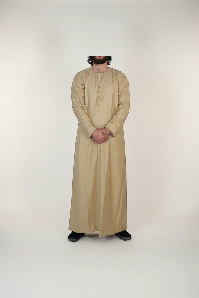 Khayr Thobes men's traditional beige thobe robe with mandarin collar and tassel detail. Relaxed fit, breathable fabric.