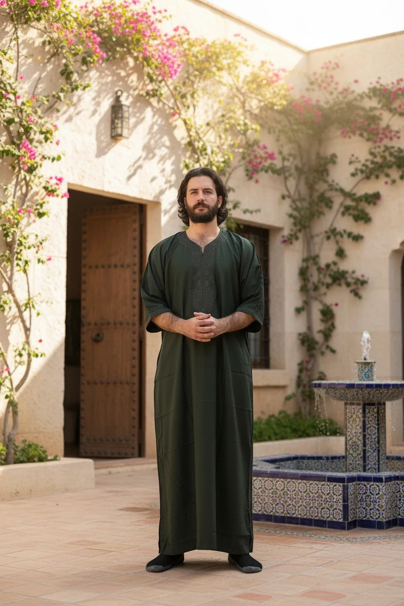 Khayr Thobes Men's Traditional Thobe Robe in deep forest green, lightweight fabric, relaxed fit, flowing sleeves, full length, with tonal embroidery on neckline and side pockets.