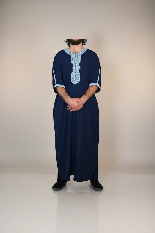 Khayr Thobes deep navy men's thobe with light blue embroidery on neckline and cuffs. Traditional long sleeve garment.