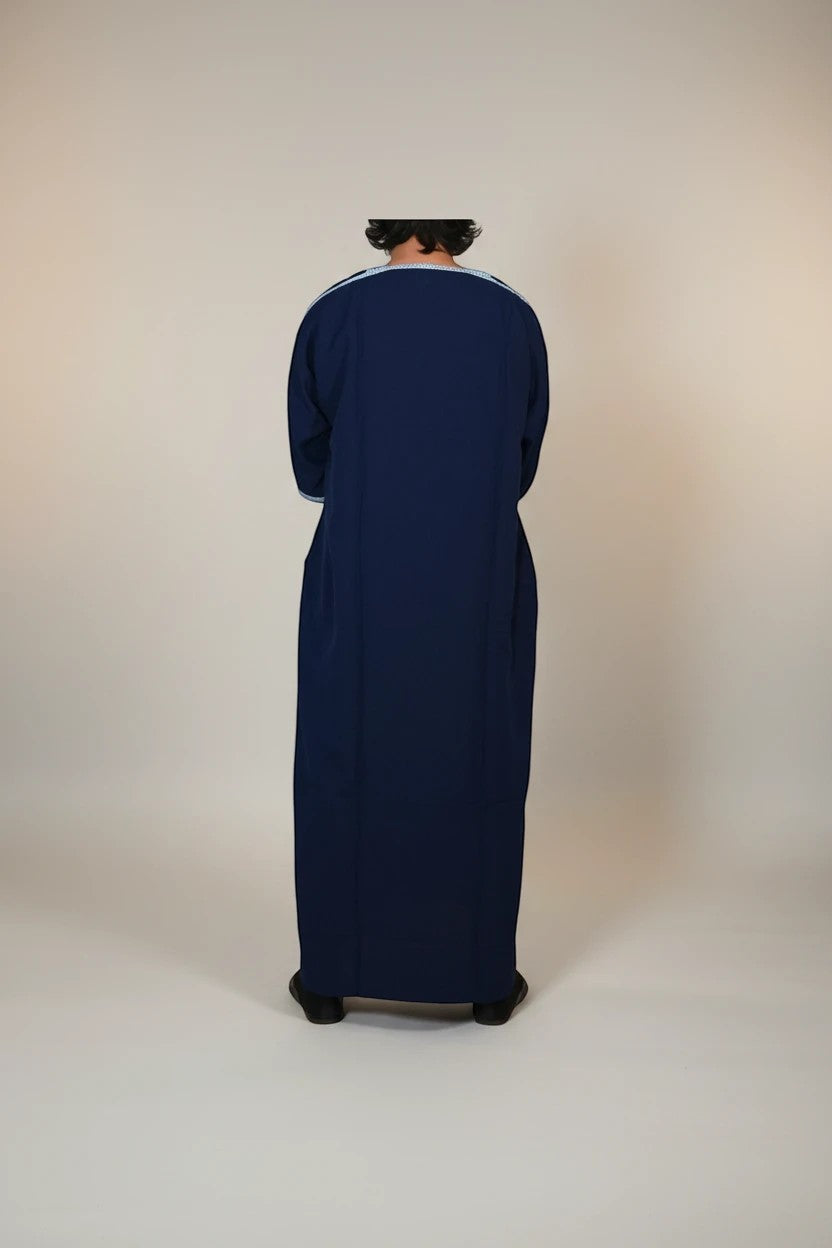 Khayr Thobes deep navy traditional thobe with light blue embroidery on neckline and cuffs. Long sleeves, flowing silhouette.