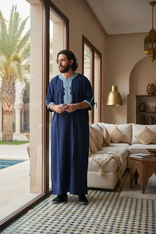 Khayr Thobes deep navy traditional thobe with light blue embroidery on neckline and cuffs. Men's modest wear.
