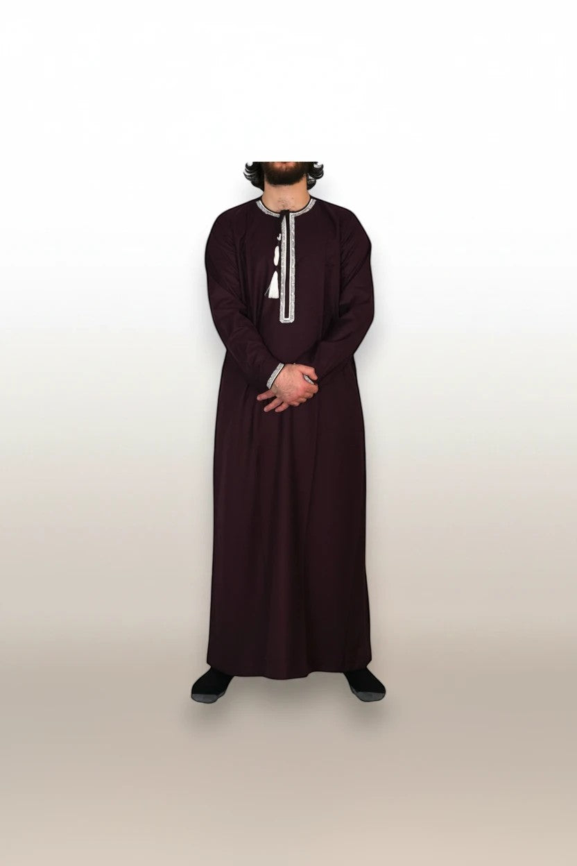 Khayr Thobes deep plum traditional thobe with white embroidery and tassel detail on a man.