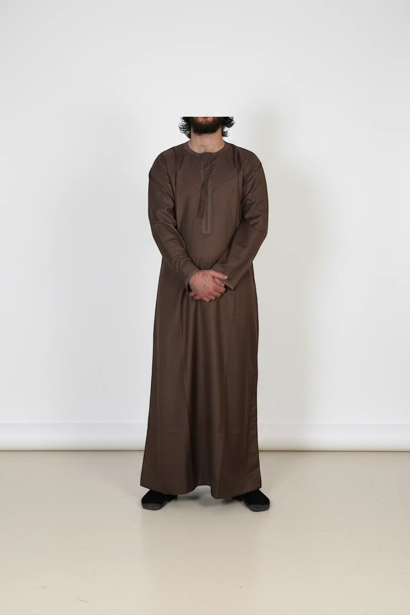 Khayr Thobes traditional brown long sleeve thobe with round neckline and subtle stitching. Made from breathable fabric.
