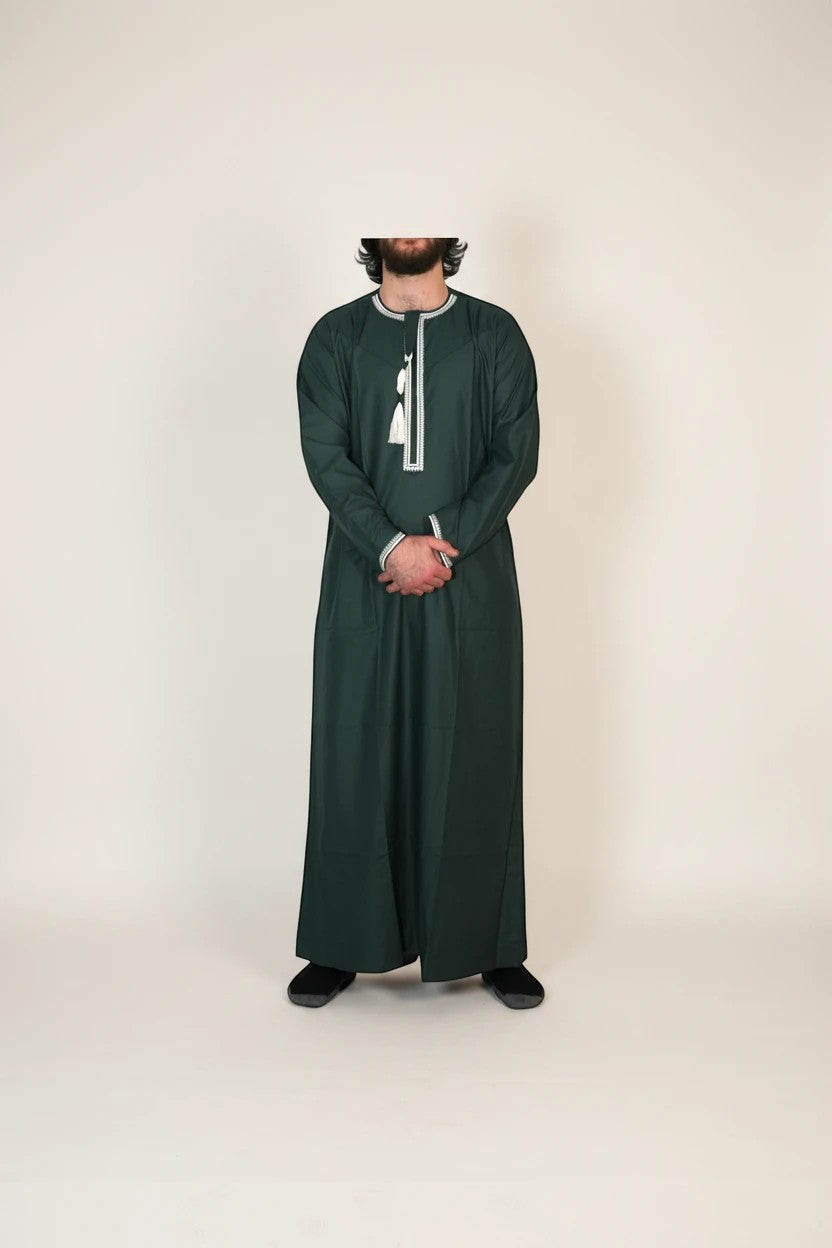 Khayr Thobes traditional Islamic thobe in deep forest green with white embroidery and tassel detail. Long sleeves, round neckline.