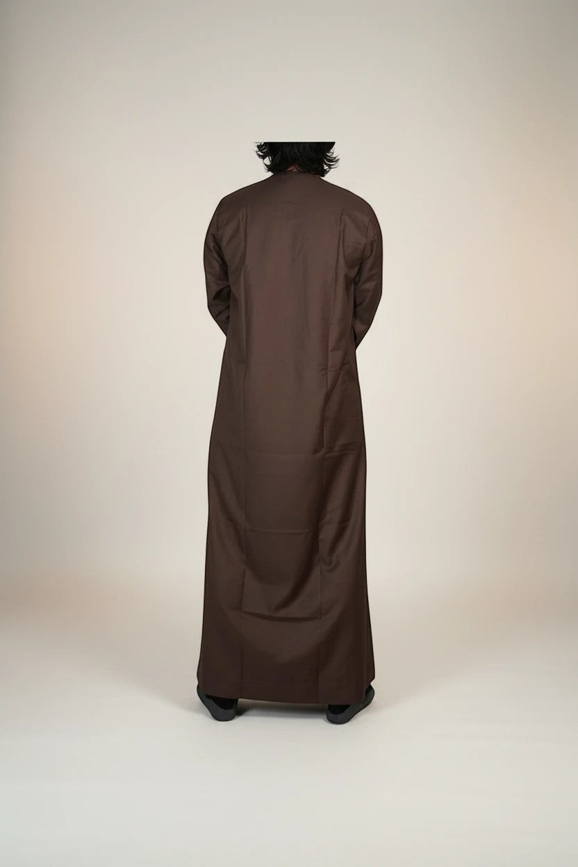 Khayr Thobes traditional long sleeve thobe in rich brown, crafted from breathable fabric with a round neckline and subtle stitching.