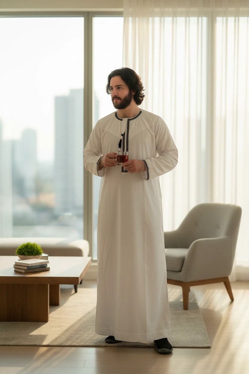 Khayr Thobes white traditional men's thobe with black embroidered neckline and cuffs.
