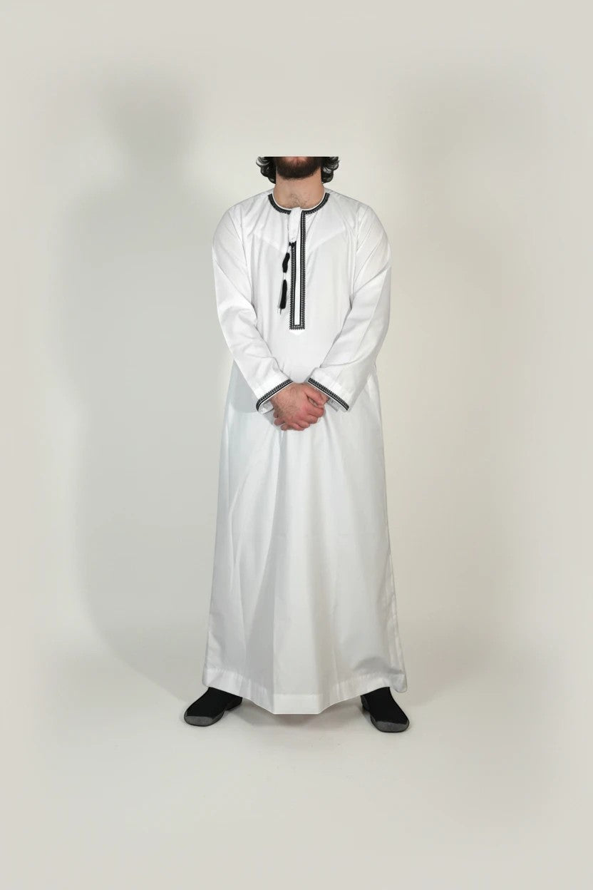 Khayr Thobes traditional white men's thobe with black embroidery and tassels. Long sleeves, crew neck.